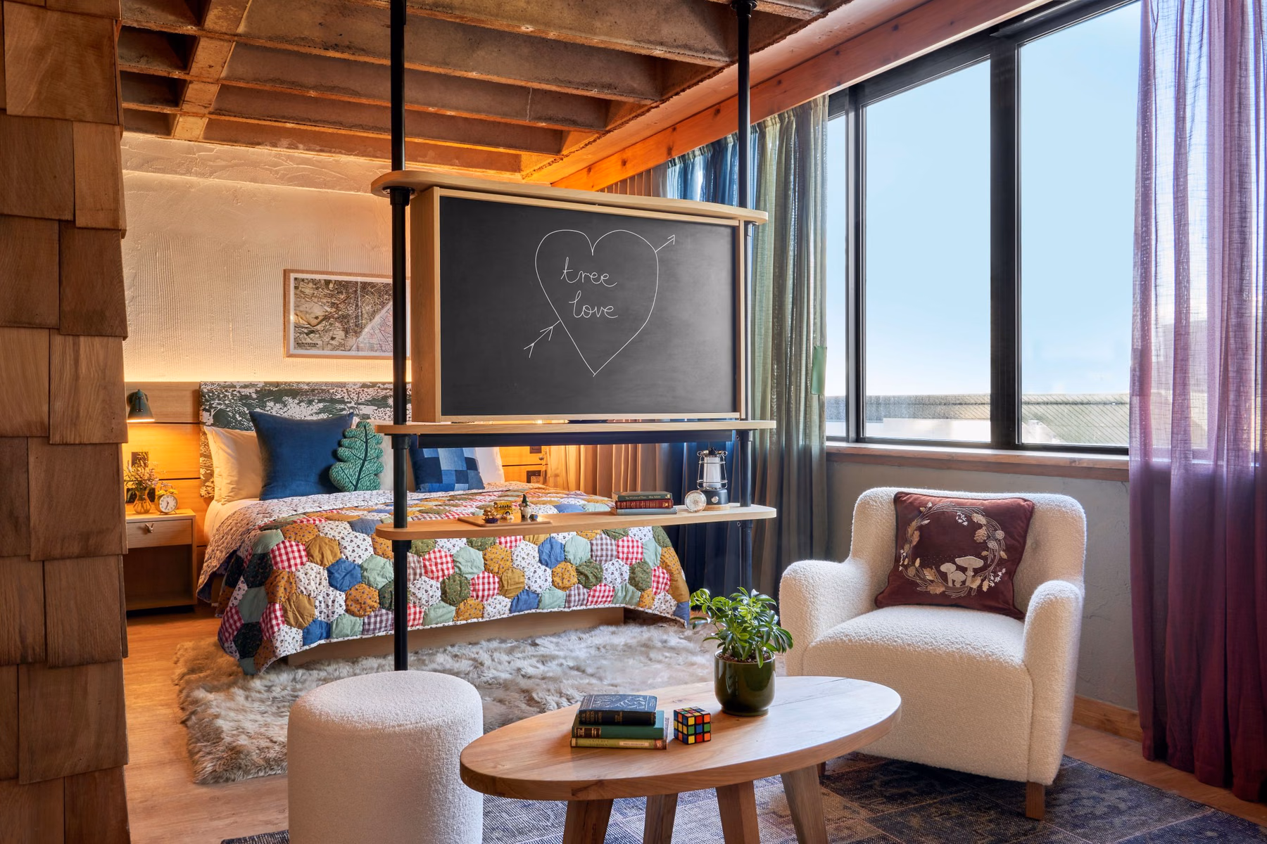The suites create a lived-in accommodation space with patchwork bedspreads, reading chairs, and a writable chalkboard. Photo / Supplied by Treehouse Hotels
