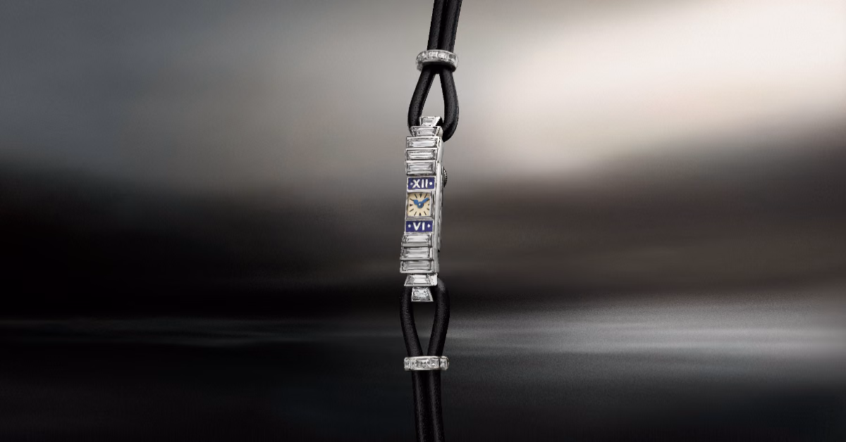 A diamond-set rectangular case paired with a slender black strap.
