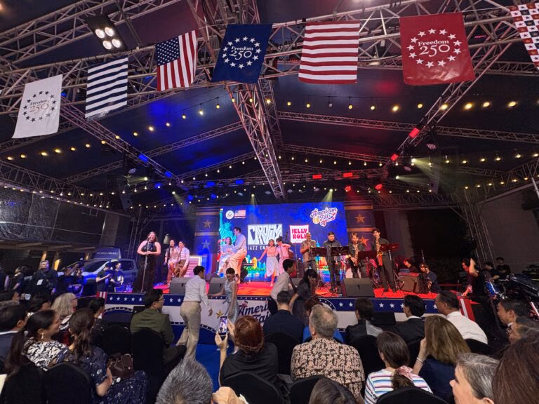 A band and audience at the American Fair stage, photographed during the event