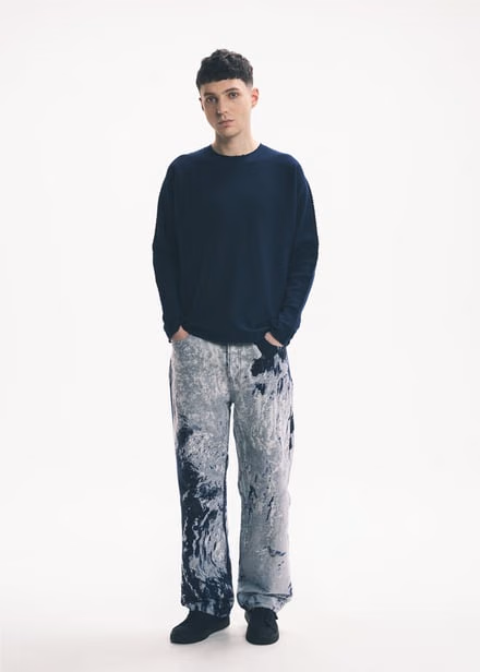 A dark top with straight jeans in white-and-blue Antarctic patterns
