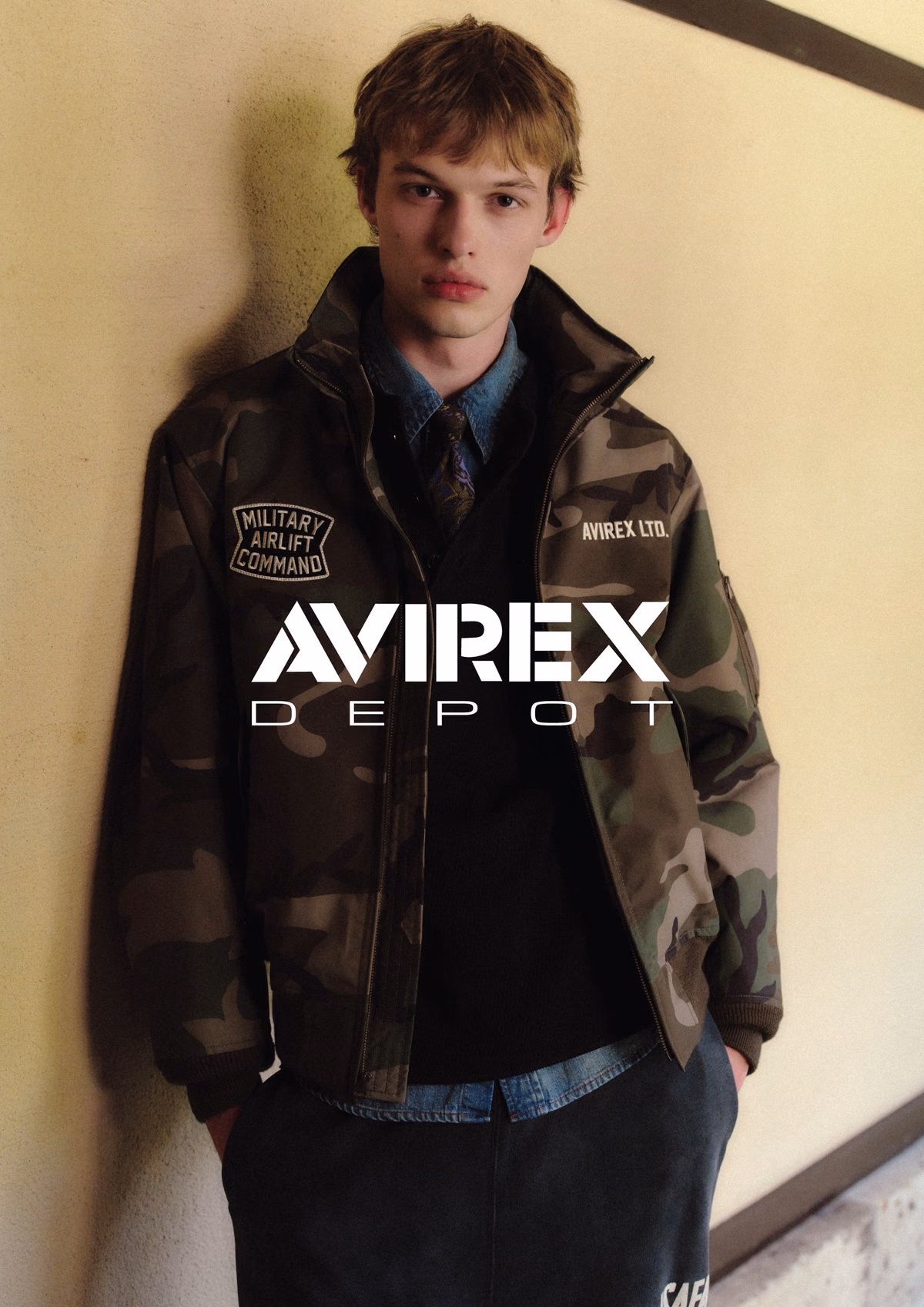 위장무늬 재킷·셔츠·넥타이의 AVIREX 홍보 스타일로 원래 브랜드 글자를 보존