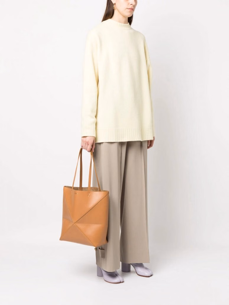 Orange Loewe Puzzle Fold tote worn at the side