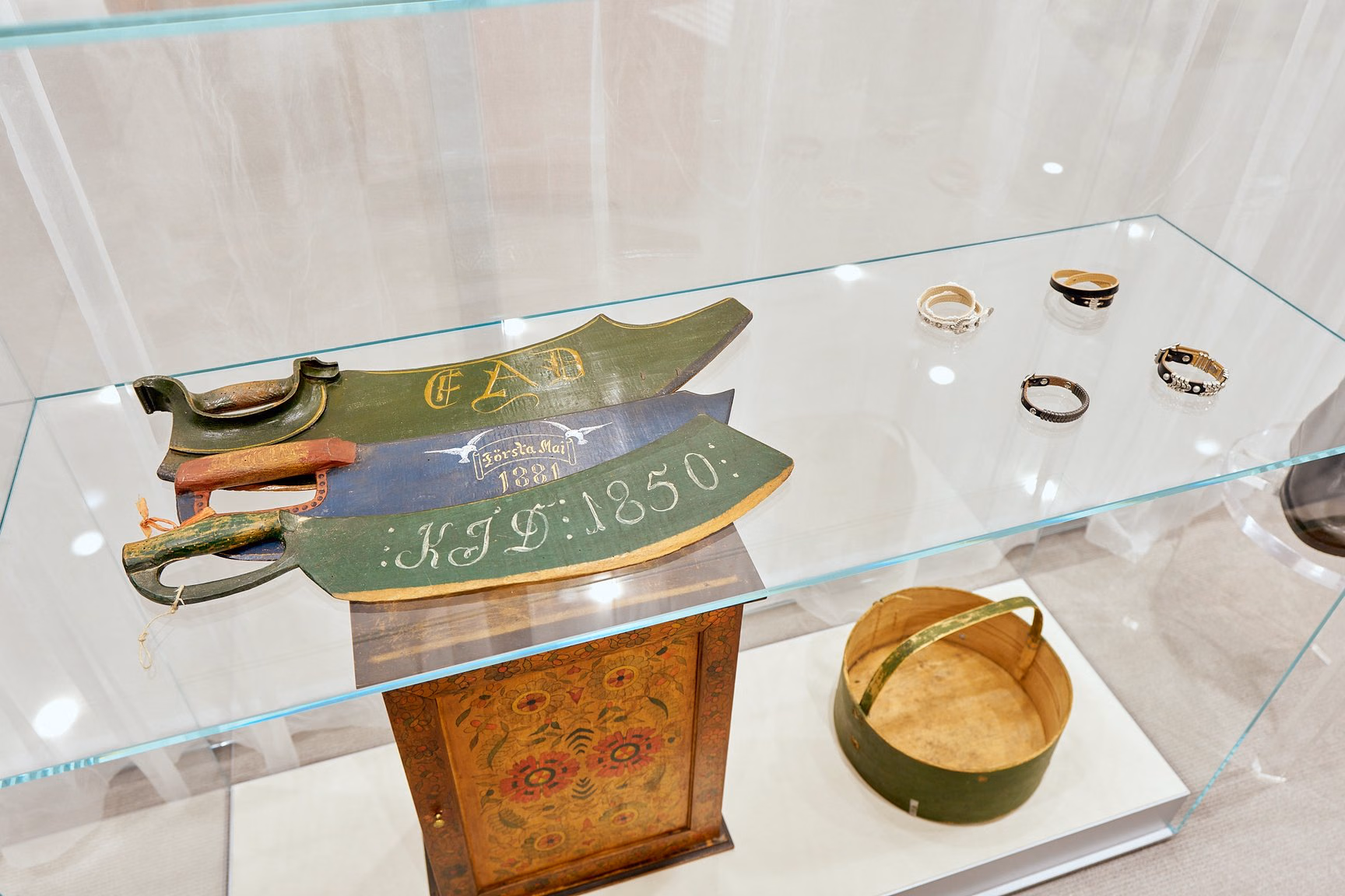Swedish traditional craft objects inside a glass display cabinet