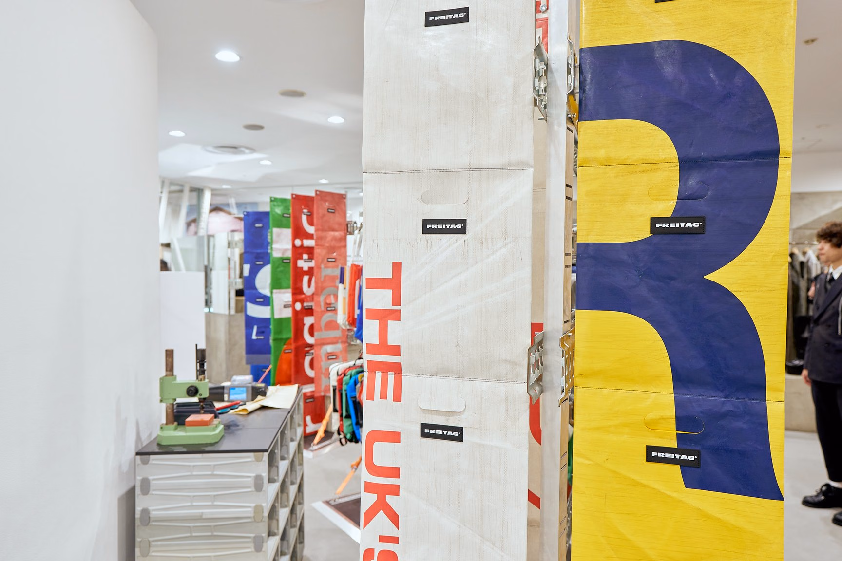 Different patterned FREITAG truck tarps suspended in the store