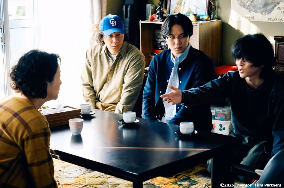A table conversation in a still from Mentor