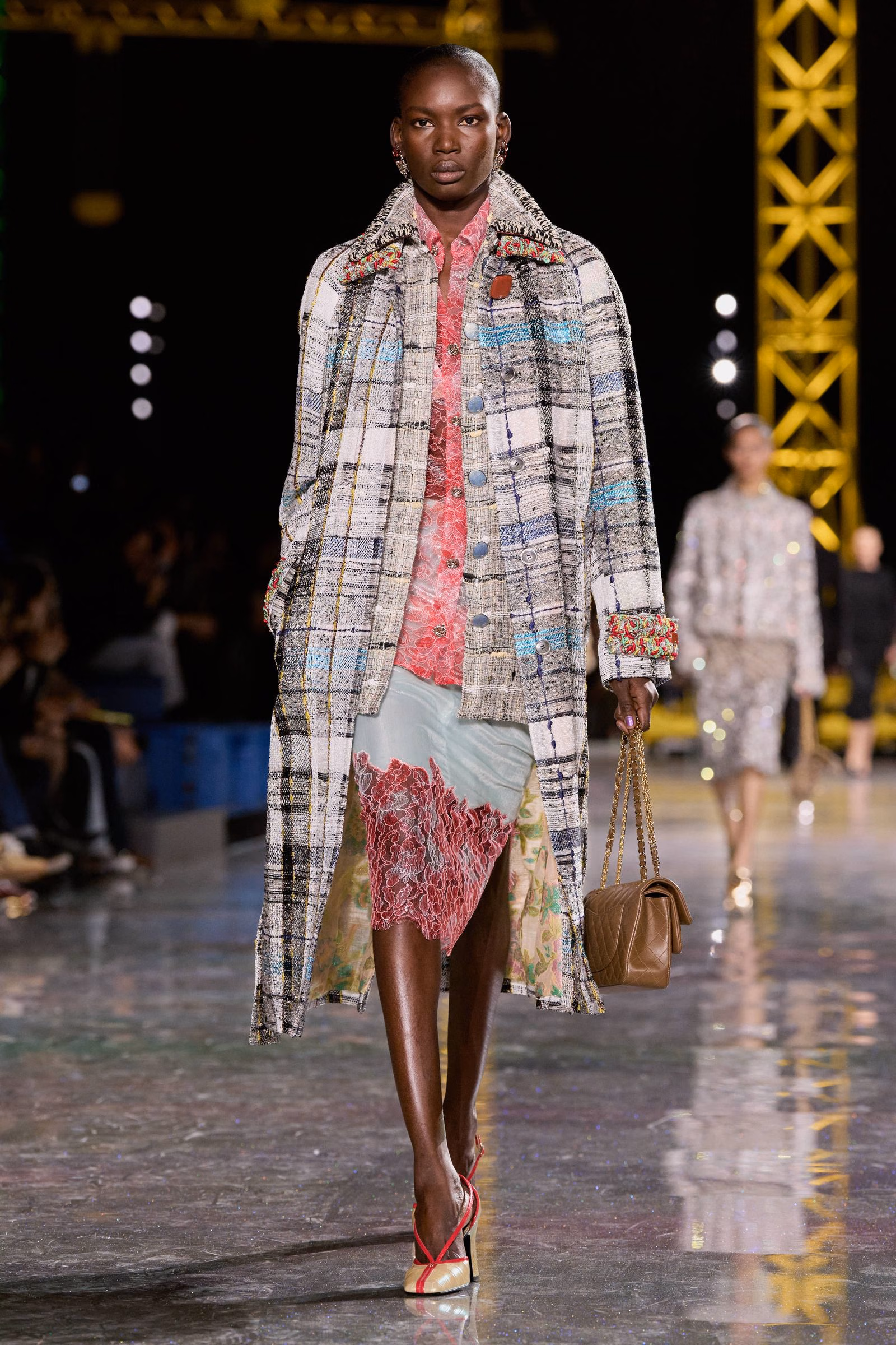 A Chanel checked tweed coat over pink lace and a skirt
