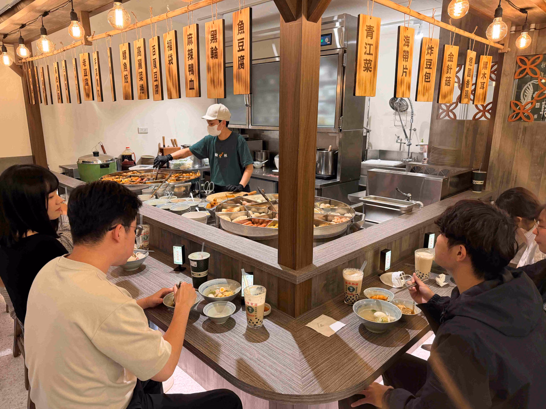 Customers seated around the oden cooking counter at Hanlin’s counter-style tea shop