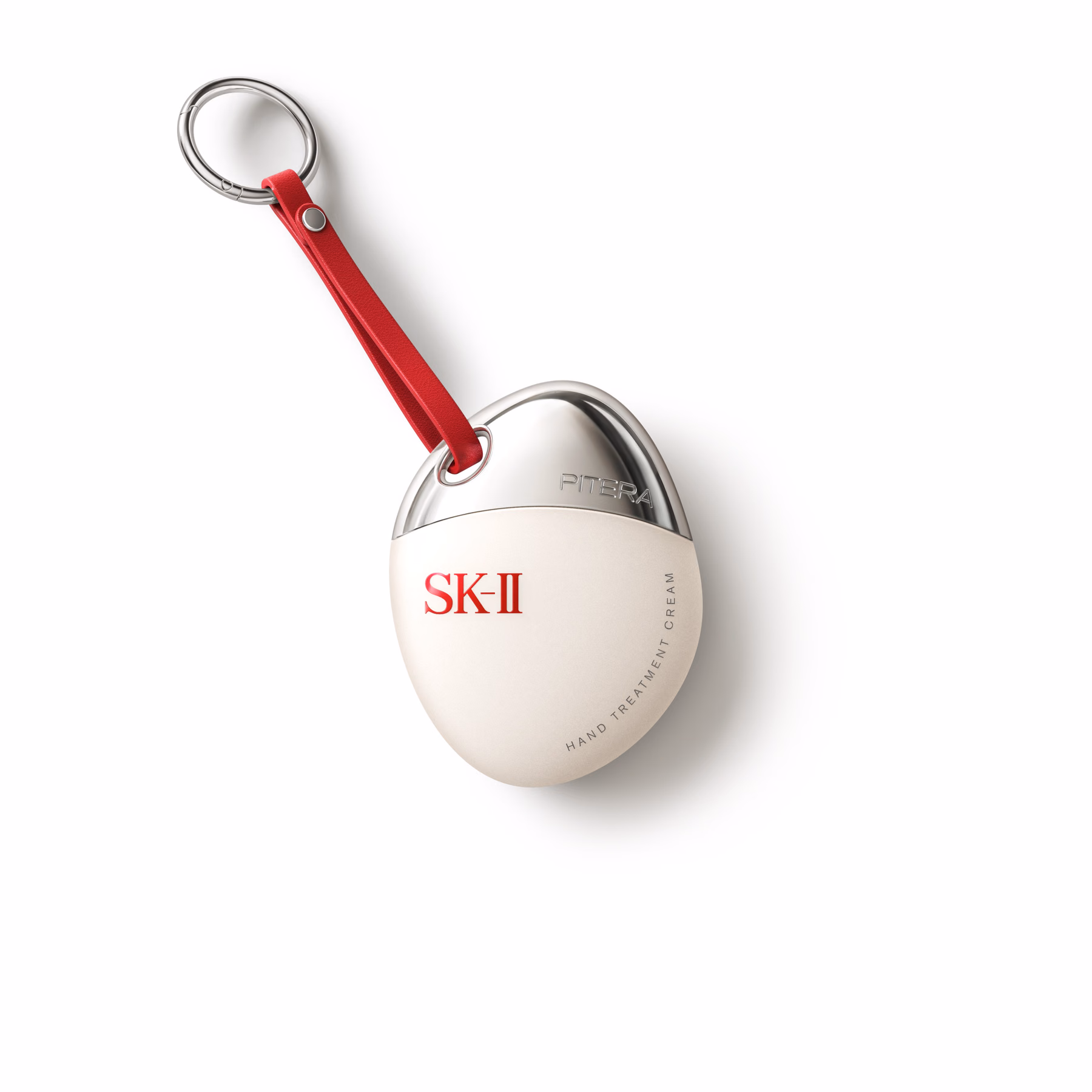 빨간 스트랩과 금속 링을 단 물방울 모양 SK-II 핸드크림