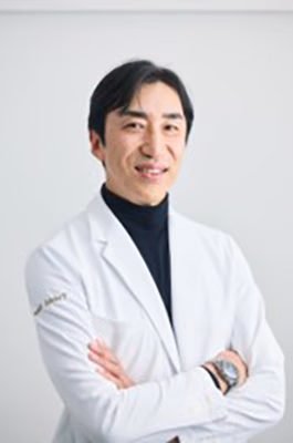 Official portrait of speaker Yuichi Sato wearing a white coat